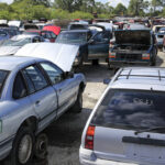 bigstock-Rusty-old-junk-cars-in-a-row-a-261407200